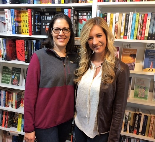 Inkwood Books owner Julie Beddingfield, left, welcomes sweepstakes winner Jennifer Kelly.