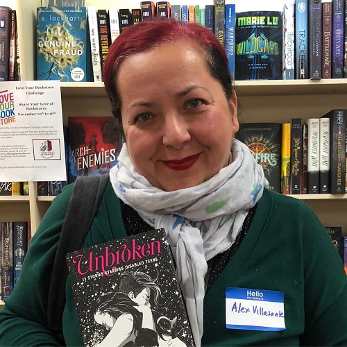 Author Alex Villasante posing with Unbroken, 13 Stories Starring Disabled Teens at Newtown Bookshop