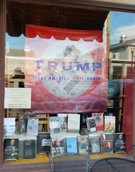 Anti-Trump banner in Inquiring Minds front window.