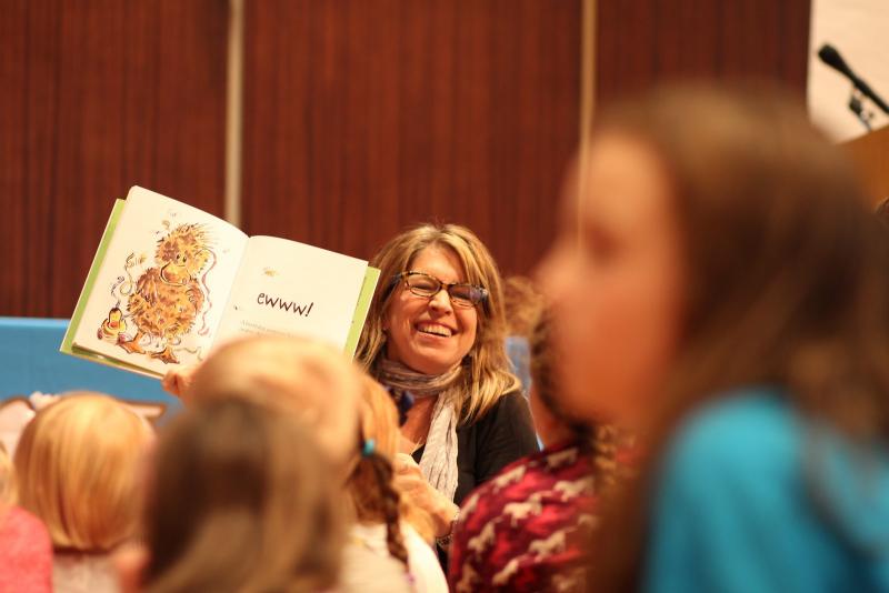 Author Doreen Cronin reads on stage during an interactive break-out sessions at Kleinhans Music Hall at the 2016 Expo.