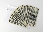 Fan of $100 bills on top of envelope