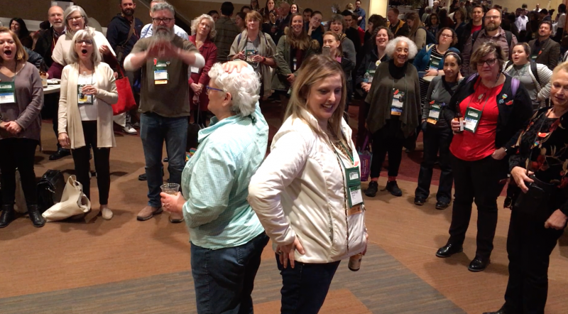 Whitney Balaun (right) won Binc's Heads or Tails fundraising game on behalf of Deon Stonehouse of Sunriver Books, with Sally McPherson of Broadway Books (left) coming in second.