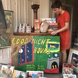 Bookseller Audrey Parks posing with her Good Night Moon inspired sign.