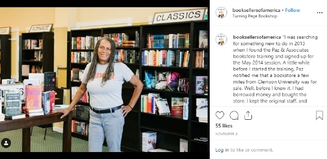 A bookseller standing in front of bookshelves in her bookstore