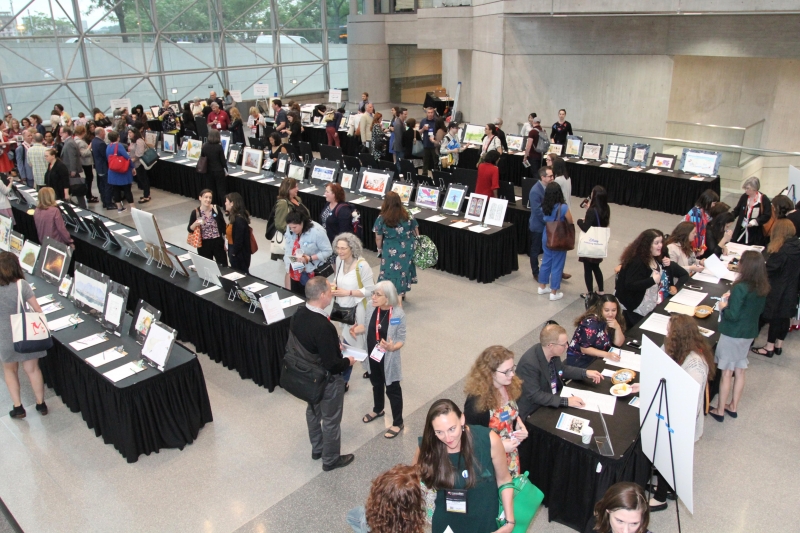 Booksellers, publishers, authors, and illustrators peruse the pieces at the 2019 Silent Art Auction to benefit ABFE and Every Child a Reader.