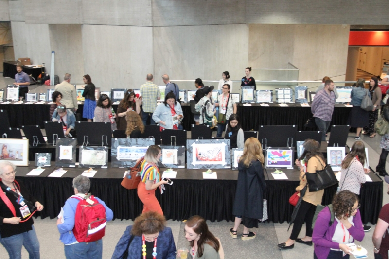 Attendees peruse the artwork at the 2019 Silent Art Auction at BookExpo.