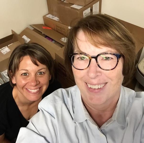 Barbara Jeremiah, right, dives into newly arrived inventory with Riverstone Books’ store manager Kristin Pidgeon.